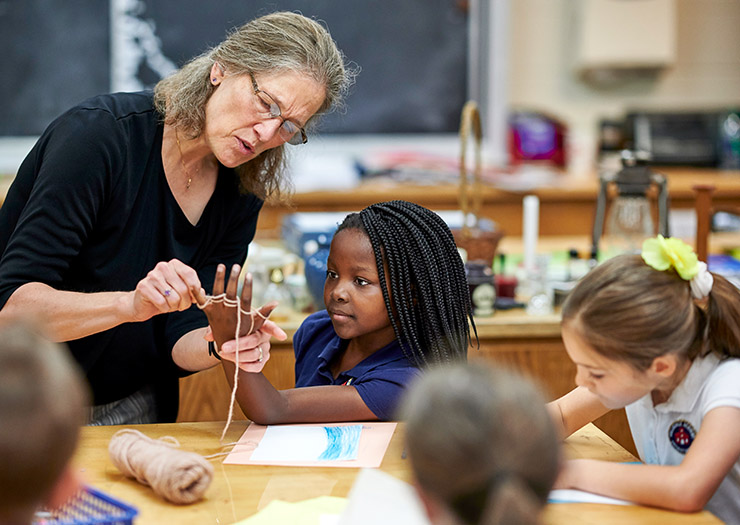 A young student with an art teacher