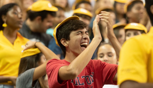 A student at Georgia Tech’s undergraduate new student convocation celebrates getting his RAT cap, a special hat given to every first-year student.