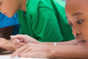 children at a table reading books