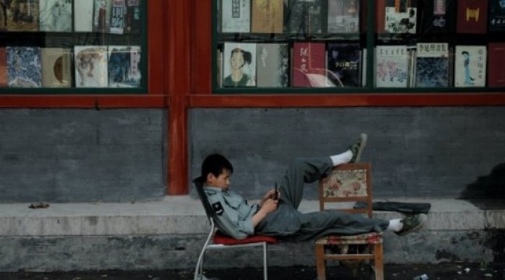 Boy lounging on chairs. 