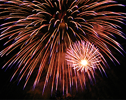 Red fireworks exploding against a black background