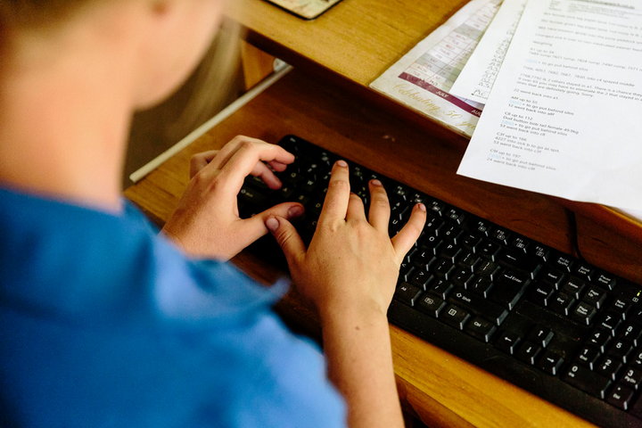 Woman typing on keyboard