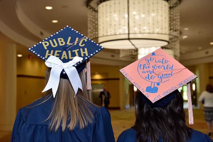 Public Health graduates in decorated mortar boards