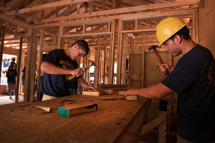 Nailing boards at home build site