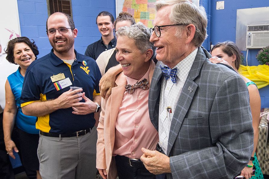 President Gee hugs center director Cris Mayo