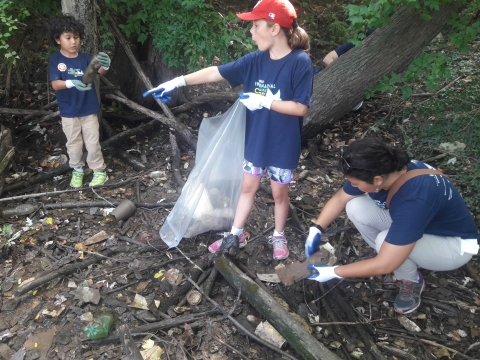 Kids cleaning up debris.