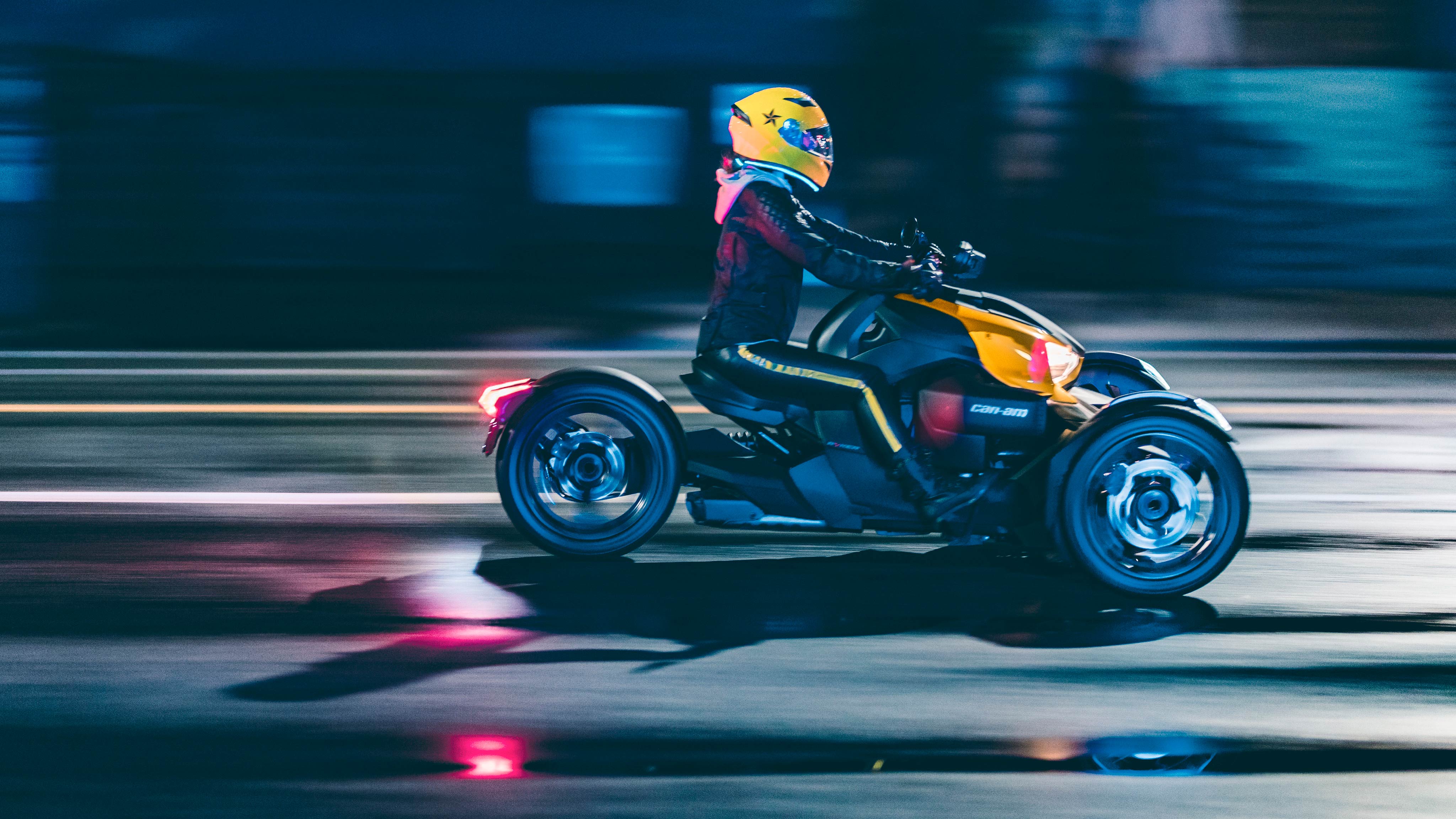 Chica conduciendo un Can-Am Ryker con casco amarillo