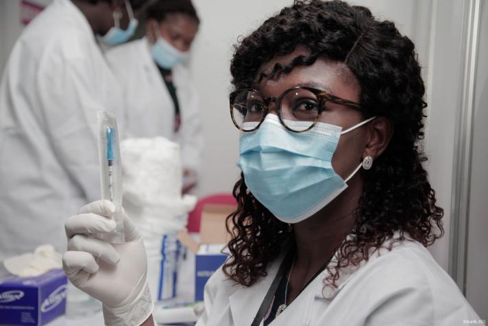 A nurse holding a syringe