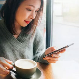 Open Banking - Woman on Phone with Coffee