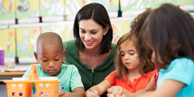 Pre-Elementary teacher helping group of students