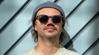 Photo of A-Tweed wearing a grey beanie and sunglasses