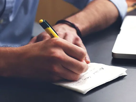 person writing on paper