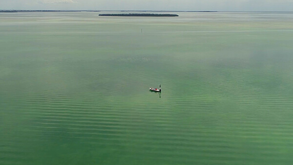 A small boat alone in a bay