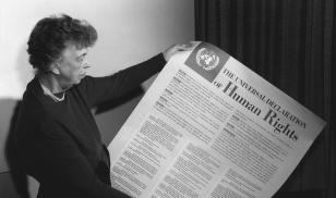 First lady Eleanor Roosevelt holding a signed copy of the United Nations declaration of Human Rights