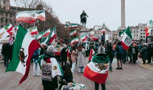 People gather in Trafalgar Square. London for a protest in support of human rights defenders and protesters in Iran.