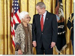 President George W. Bush and Virginia Ganzon-Sturwold of San Francisco exchange glances during the presentation of the President's Volunteer Service Award during a celebration of Asian Pacific American Heritage Month in the East Room Friday, May 12, 2006. White House photo by Paul Morse