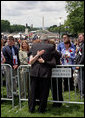 President George W. Bush embraces law enforcement family members during an emotional moment at the Annual Peace Officers' Memorial Service at the U. S. Capitol Monday, May 15, 2006. The service honors fallen federal, state and local law enforcement officers. White House photo by Kimberlee Hewitt