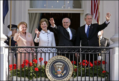 President George W. Bush, Prime Minister John Howard, Mrs. Laura Bush and Mrs. Janette Howard wave from the South Portico of the White House during the State Arrival Ceremony on the South Lawn Tuesday, May 16, 2006. White House photo by Paul Morse