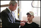 President George W. Bush pins a Purple Heart on Cpl. Joel Dulashanti of Cincinnati, during a visit Tuesday, July 3, 2007, to Walter Reed Army Medical Center in Washington, D.C., where the soldier is recovering from wounds received in Operation Iraqi Freedom. White House photo by Eric Draper