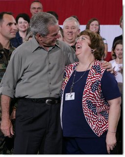 President George W. Bush embraces Joy Enders, president of the 167th Airlift Wing Family Readiness Group, Wednesday, July 4, 2007, during a Fourth of July visit with members of the West Virginia Air National Guard 167th Airlift Wing and their family members in Martinsburg, W. Va. President Bush thanked Enders and members of her organization for their mission to care for the families of deployed Guard members. White House photo by Chris Greenberg