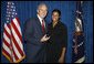 President George W. Bush stands with Keela Carr, a 35-year-old fitness and athletic trainer, shortly after his arrival Wednesday, Aug. 20, 2008, in Orlando, Florida. Ms. Carr was recognized by the U.S. Army's Freedom Team Salute Program and named its 500th Volunteer Ambassador in recognition of her 2008 2,700-mile, trans-America Journey of a Thousand Thanks to honor and thank all soldiers and veterans. White House photo by Eric Draper