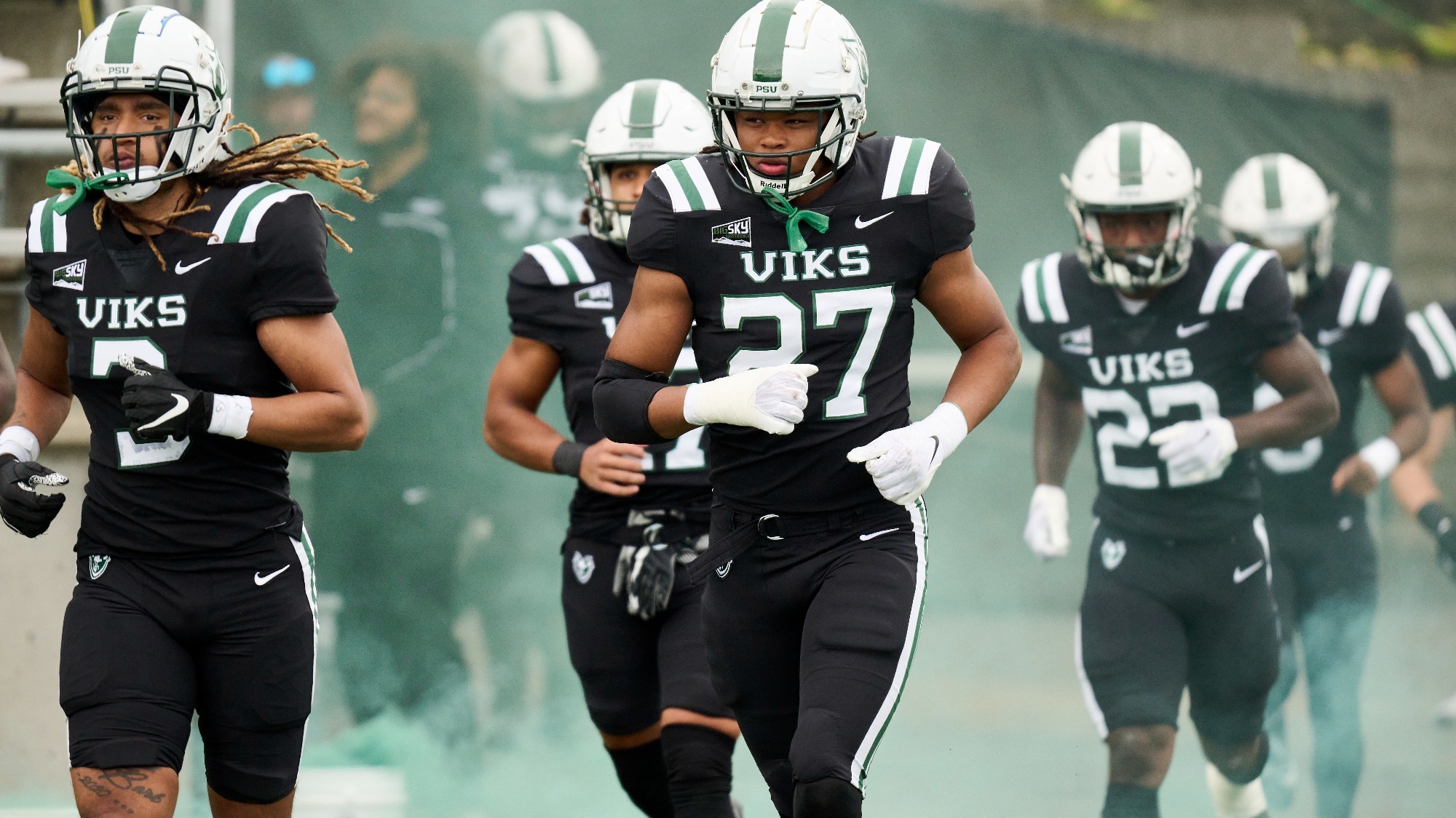 The Viking football team comes out of the locker room in preparation for a home game with Cal Poly