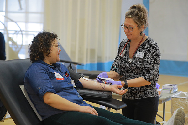 A UToledo Health employee working with a patient reclined in a chair