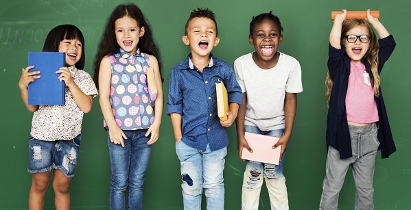 image of a group of elementary aged children in front of a chalk board