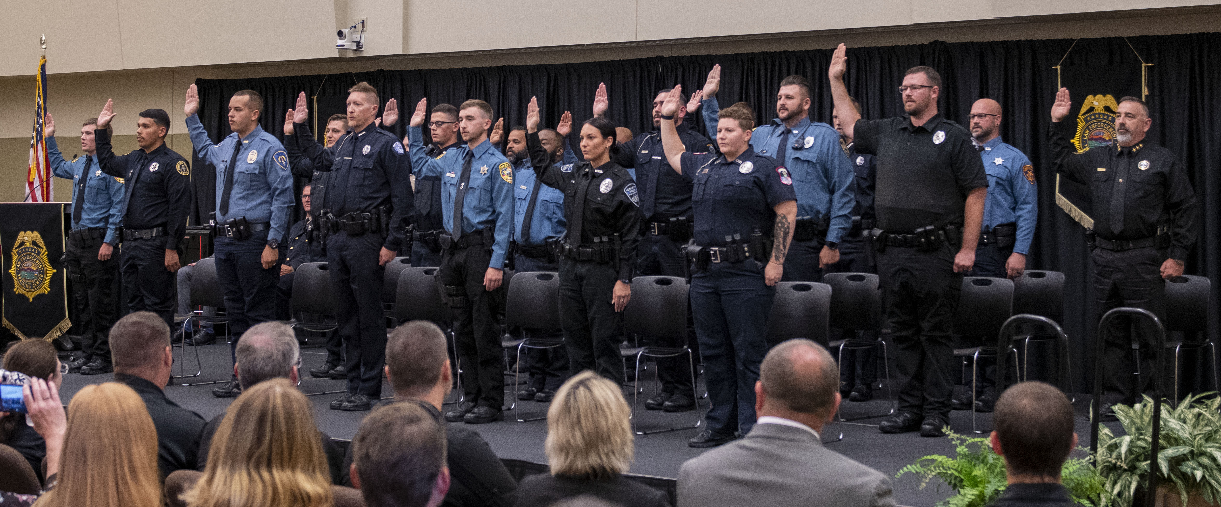 The 281st Basic Training Class recites the Law Enforcement Oath of Office in front of the attending audience.