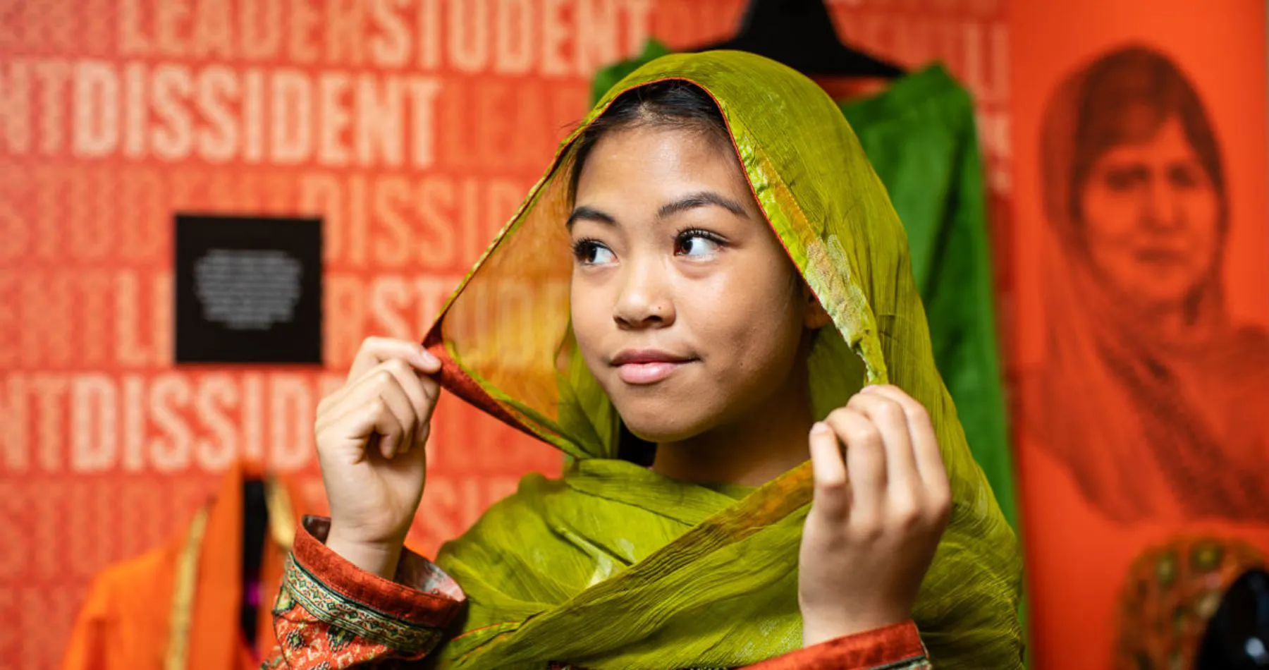 A young visitor trying on the exhibition outfits