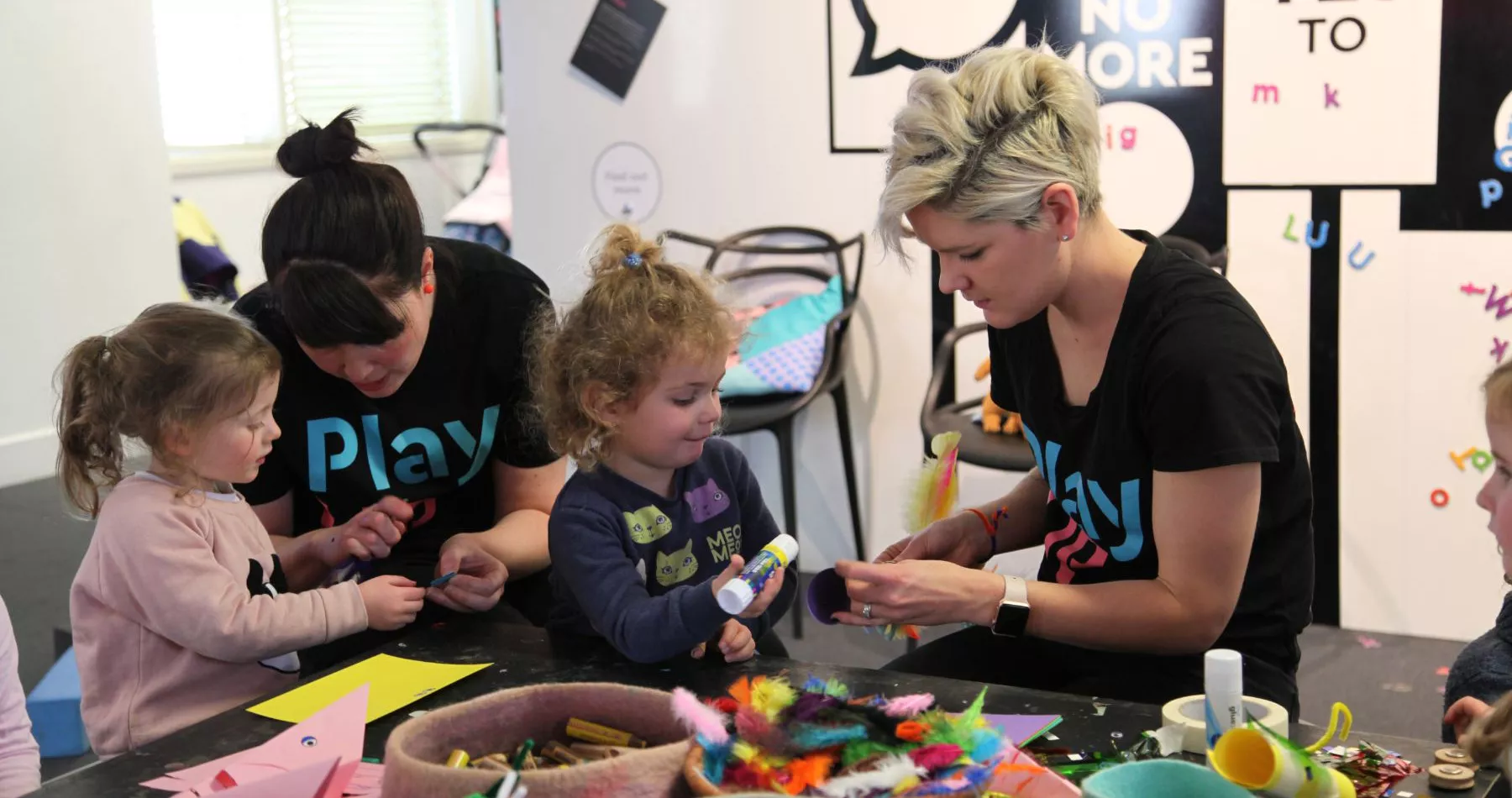 Two children playing with two PlayUP staff members