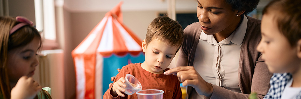 Teacher working at a table with a student