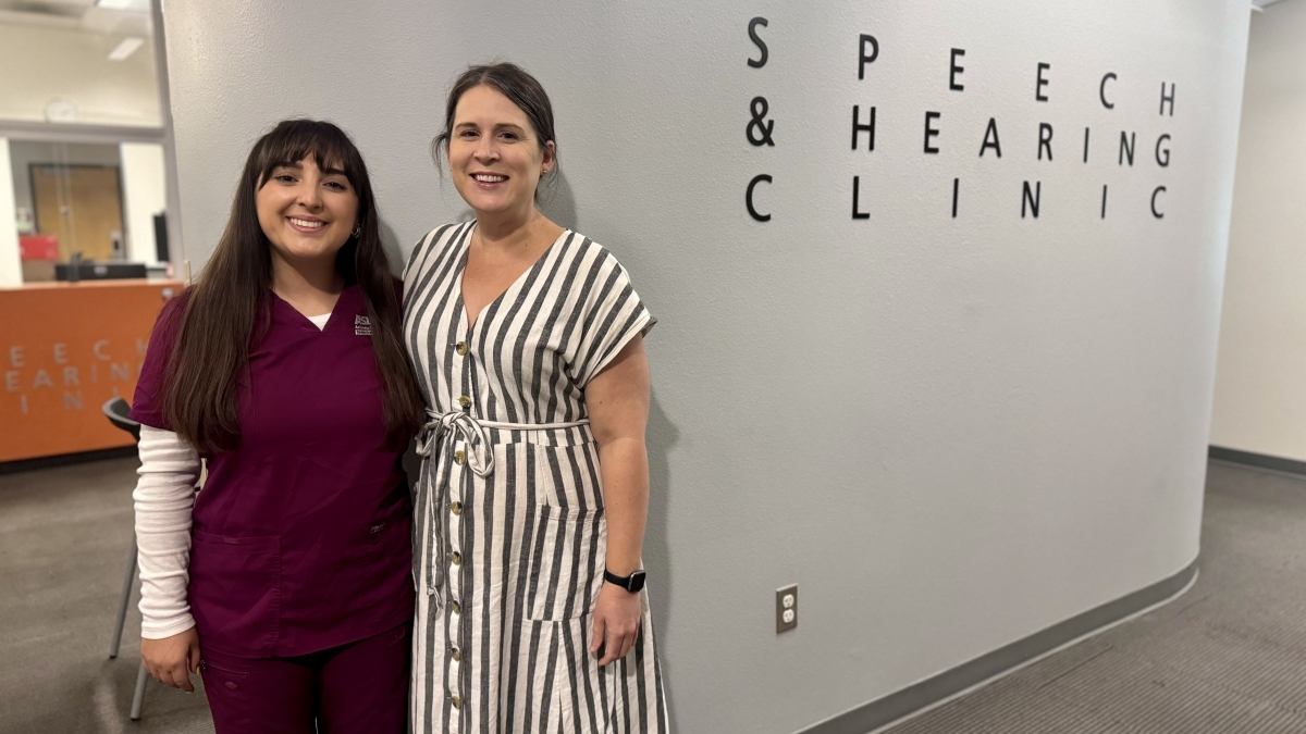 Two women pose in ASU's Speech and Hearing Clinic