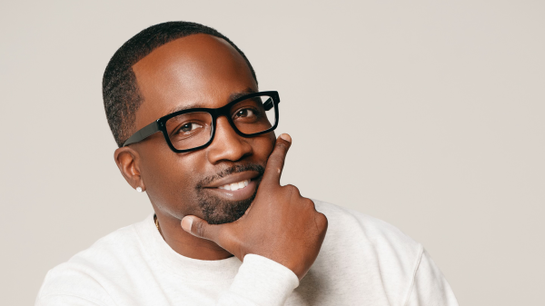 Headshot of Tuo Clark wearing glasses and wearing a white shirt