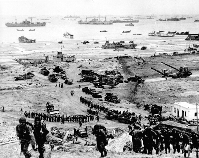 Reinforcing Omaha Beach with men and equipment.