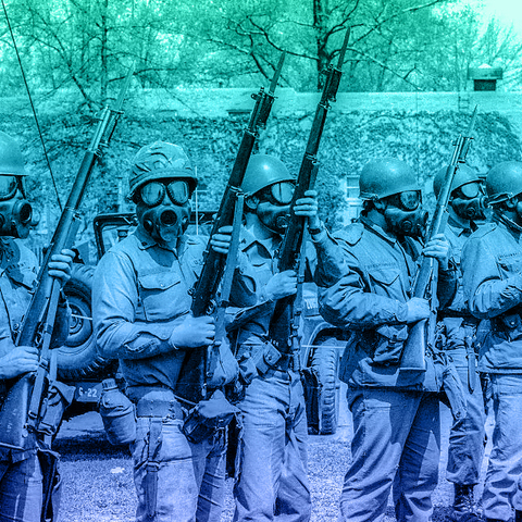 National Guard Soldiers wearing gas masks and holding rifles