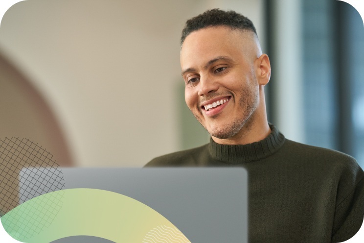 A person working on a laptop with a smiling face