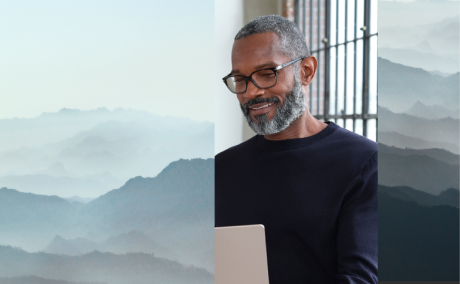 Collage image of a person working on their laptop with a neutral landscape background