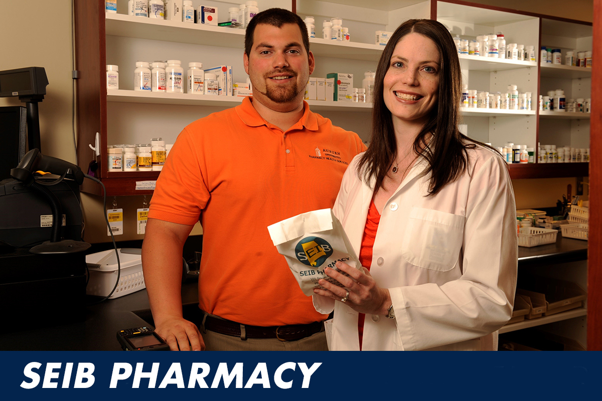 Pharmacist and staff member behind the counter