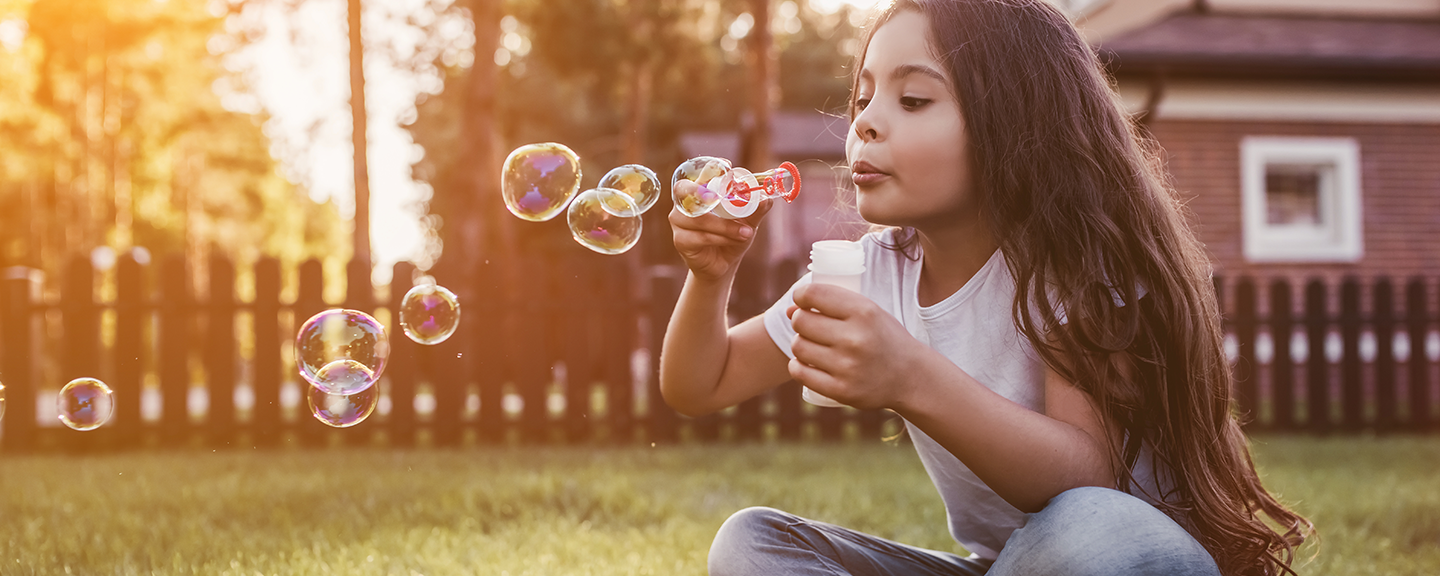 girl blowing bubbles