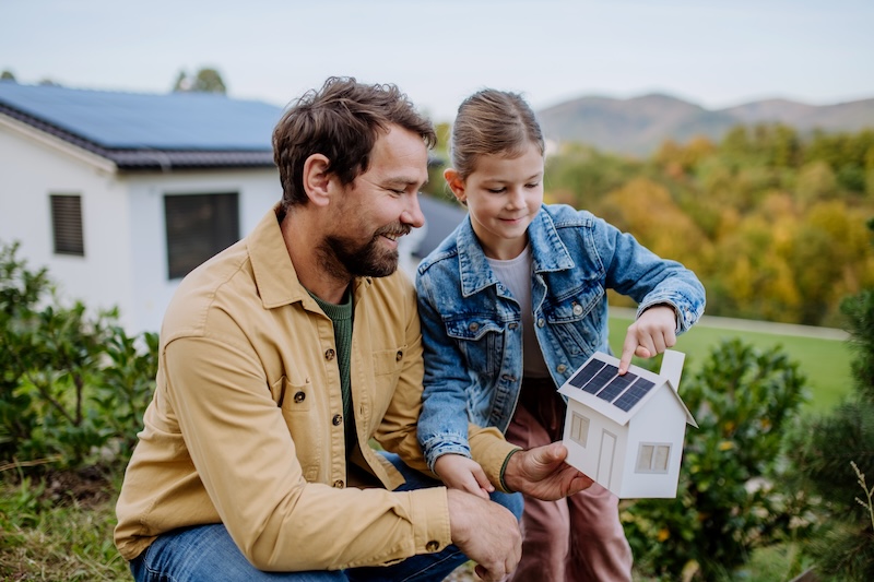 Parent and child with solar home