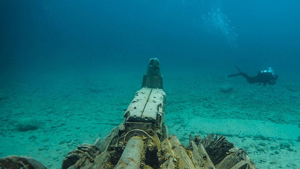 Diver swimming near a shipwreck