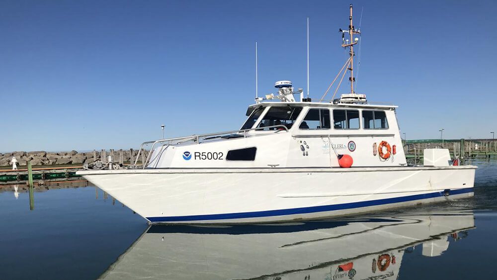 a white vessel with the national oceanic and atmospheric administration logo on the side