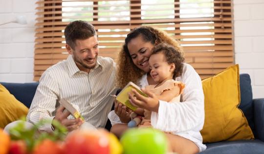 Parents with very young child looking at a book