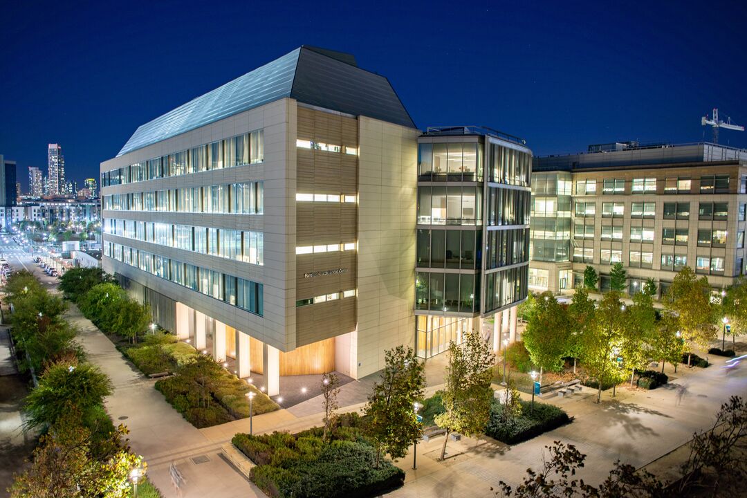 Nighttime view of Mission Bay Campus with the San Francisco City skyline in the background