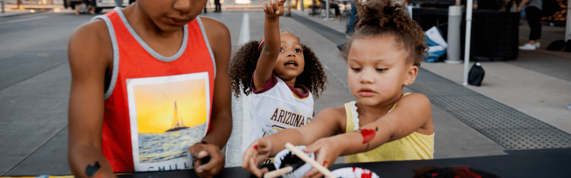 Children painting at a Game Day event for Sun Devil Athletics