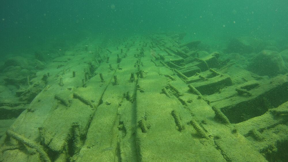 Wood from a shipwreck rests on the lakebed