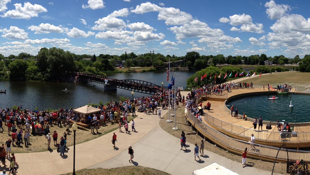 A view of a crowd gathered near a river