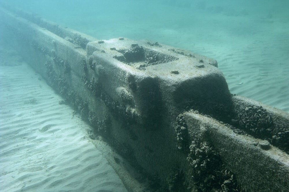 parts of a shipwreck rest on a lake bed