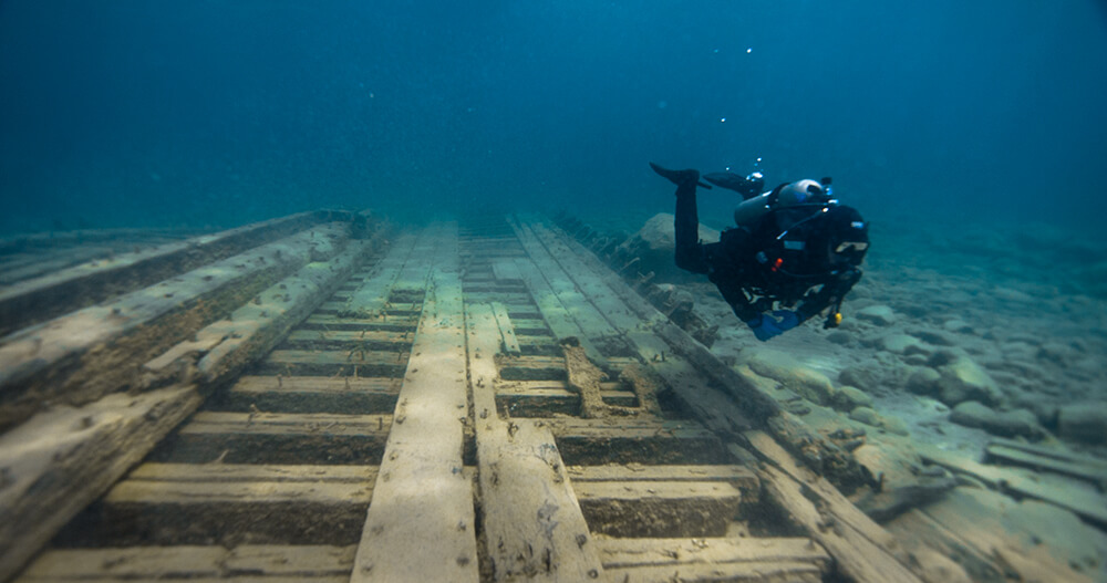 A diver swims above a shipwreck